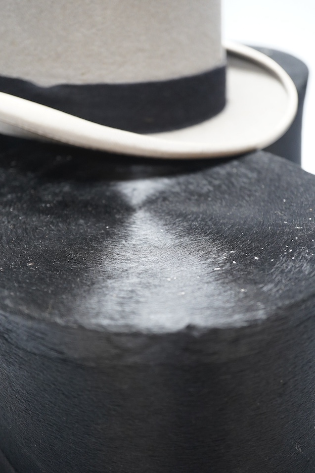 Three gentlemen’s black silk top hats and a similar grey top hat and box. Condition - grey hat good, others poor